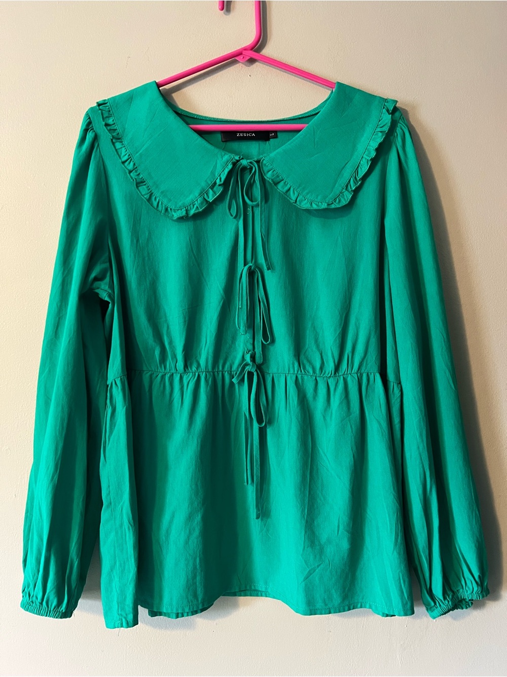 Zesica size L emerald green babydoll blouse with bodice ties and elastic waist.
